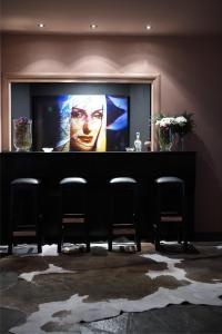 a large screen with a picture of a man on the wall at Art Hotel Mirtali in Dodoni