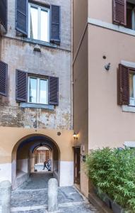 an alleyway between two buildings with windows at Castel Sant'Angelo Apartments - Exclusive & Luxury in Rome