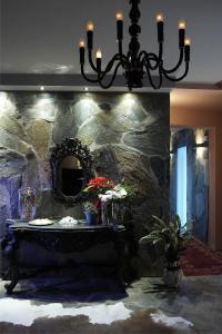 a room with a stone wall with a table and a mirror at Art Hotel Mirtali in Dodoni