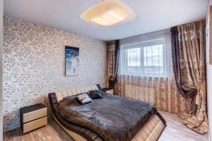 a bedroom with a bed and a window at Apartment near center in Klaipėda