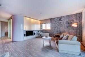 a living room with a couch and a tv at Apartment near center in Klaipėda