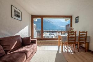 a living room with a couch and a table and chairs at Nice Studio With Balcony In Chamonix in Chamonix