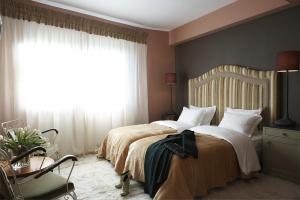 a bedroom with two beds and a window at Art Hotel Mirtali in Dodoni