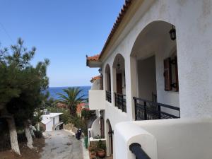 a white building with a view of the ocean at Nikos Apartments A7 in Gialiskari