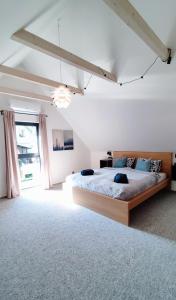 a bedroom with a large bed and a large window at BIKE HAVEN - jacuzzi - mountain biking and hiking in Nové Město pod Smrkem