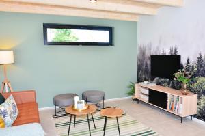 a living room with a couch and a tv at BIKE HAVEN - jacuzzi - mountain biking and hiking in Nové Město pod Smrkem