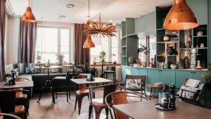 a restaurant with tables and chairs at Home Hotel Uppsala in Uppsala