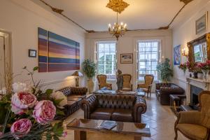 a living room with couches and a fireplace at La Collinette Hotel, Cottages & Apartments in St Peter Port