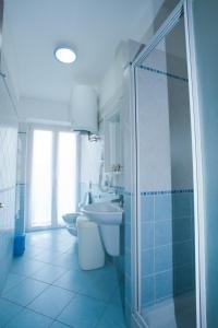 a bathroom with a shower and a toilet and a sink at Residence Cielo e Mare in Moneglia