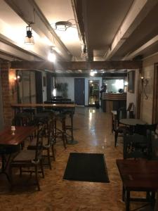 a restaurant with wooden tables and chairs and a room with tables at Moon River in Saint-Junien