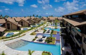 arial view of a pool at a resort at Condominio Nui Supreme - By Maya - Muro Alto - Porto de Galinhas in Porto De Galinhas