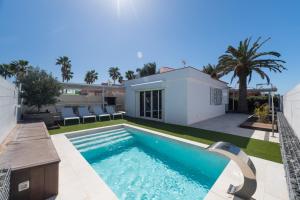 a swimming pool in the backyard of a house at Casa Maspalomas private pool, Bbq and private parking in Maspalomas