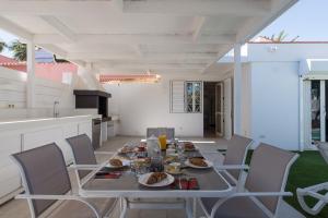 stół z talerzami jedzenia na patio w obiekcie Casa Maspalomas private pool, Bbq and private parking w mieście Maspalomas
