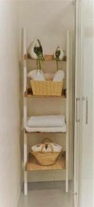 a closet with baskets and towels in a bathroom at San José Apartamentos Turísticos Miky in Albacete