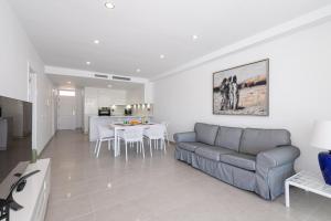 a living room with a couch and a table at BLUE SEA II - FRONT BEACH in Puerto de Mogán