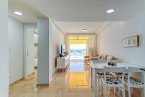 a kitchen and living room with a table and chairs at BLUE SEA I in Puerto de Mogán +14 photos