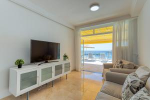 a living room with a tv and a couch at BLUE SEA I in Puerto de Mogán