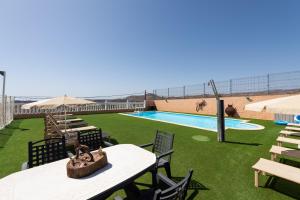 a resort with a swimming pool and a beach at Casa Adara - Heated pool included in San Bartolomé