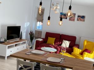 a living room with a red couch and yellow chairs at Relax601 in Braşov