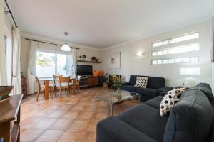 a living room with a couch and a table at House Relax&Paradise in Maspalomas