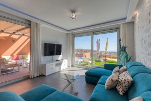 a living room with a blue couch and a television at Casa ISLA in Salobre