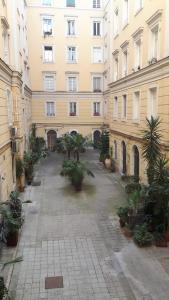 a city street with a large building with a clock on it at Residenza Vatican Suite in Rome