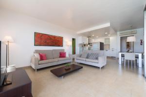 a large living room with two couches and a table at Villa Sunset Golfers in La Playa de Arguineguín
