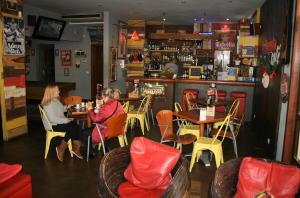 two women sitting at a table in a restaurant at Albufeira INN - Casa Litty - Bellavista T1 duplex in Albufeira