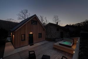 an overhead view of a house with a hot tub on a deck at Holzhaus Sikonda in Komló