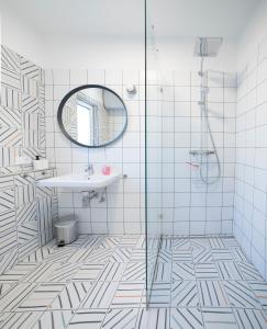 a bathroom with a shower and a sink and a mirror at Holzhaus Sikonda in Komló +21 photos