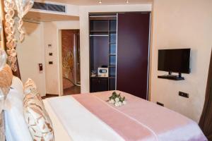 a hotel room with a bed with a flower arrangement on it at Les Fleurs Boutique Hotel in Sofia