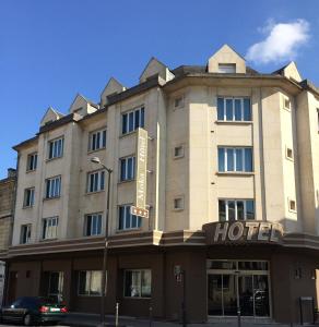 a hotel on a street with a car in front of it at Moka Hotel in Niort