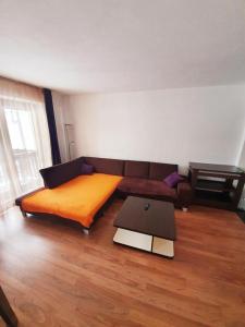 a living room with a couch and a table at Apartmán 27, Kamzík in Donovaly