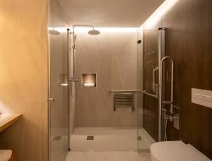 a shower with a glass door in a bathroom at CALM SUITES Molino Corteza del Carmen in Granada +86 photos