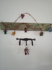 a wooden sign with the words freedomants on it at Calma in Perdika