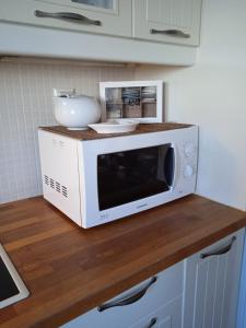 a microwave sitting on top of a counter at Calma in Perdika