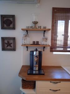 a coffee maker on a counter in a kitchen at Calma in Perdika