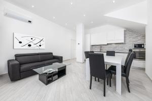 a living room with a black couch and a table at Residenze Niguarda in Milan