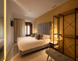 a hotel room with a bed and a chair at CALM SUITES Molino Corteza del Carmen in Granada