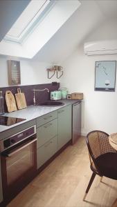 a kitchen with a sink and a stove top oven at Le studio d’Ambre in Chalon-sur-Saône