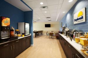 a fast food restaurant with a counter and a cafeteria at Days Inn & Suites by Wyndham Altoona in Altoona