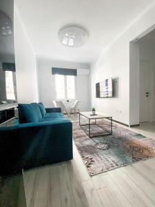 uma sala de estar com um sofá azul e uma mesa em Diamond apartment em Tessalônica