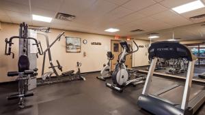 a gym with several treadmills and exercise bikes at Best Western Plus Raton Hotel in Raton