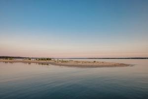 an island in the middle of a body of water at The Shoals Suites & Slips in Southold