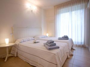 Postel nebo postele na pokoji v ubytování Lenno village Apartment-POOL, PARKING, GARDEN-by Italian Apartments