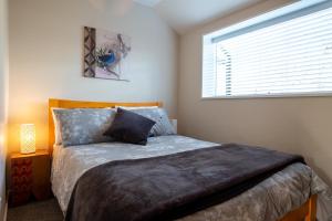 a bedroom with a large bed with a window at 40c Scarborough Tce in Hanmer Springs