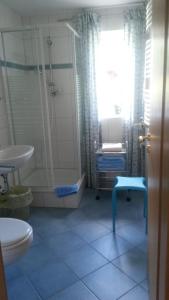 a bathroom with a toilet and a sink at Ferienwohnung Villa Bella Vista in Bad Sachsa