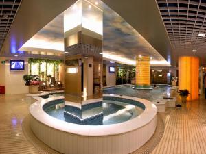 a lobby with a hot tub in the middle of a building at Shenzhen Kaili Hotel, Guomao Shopping Mall in Shenzhen