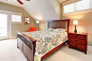 a bedroom with a bed and a dresser and a window at Sheepscot Gardens in Edgecomb