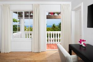 a dining room with a view of the ocean at Le Soleil D'or in Cayman Brac